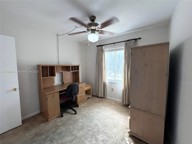 carpeted office with ceiling fan