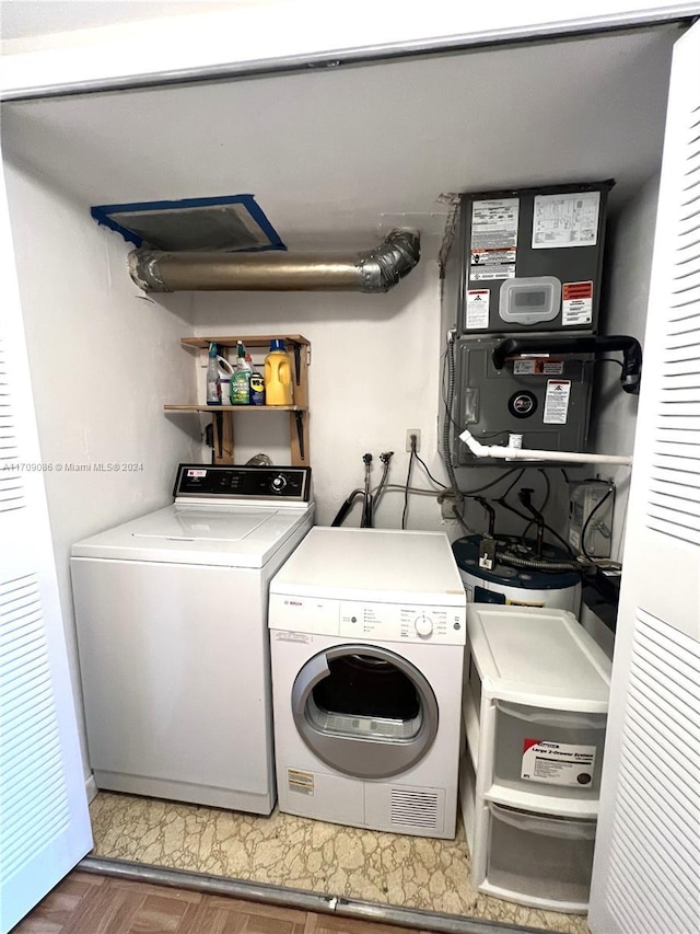 washroom featuring washer and dryer and dark parquet floors