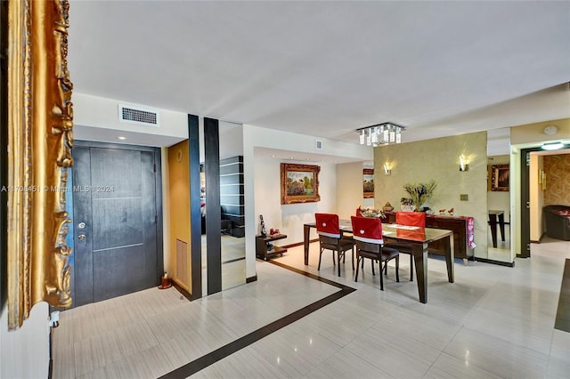 dining space featuring light tile patterned flooring and an inviting chandelier