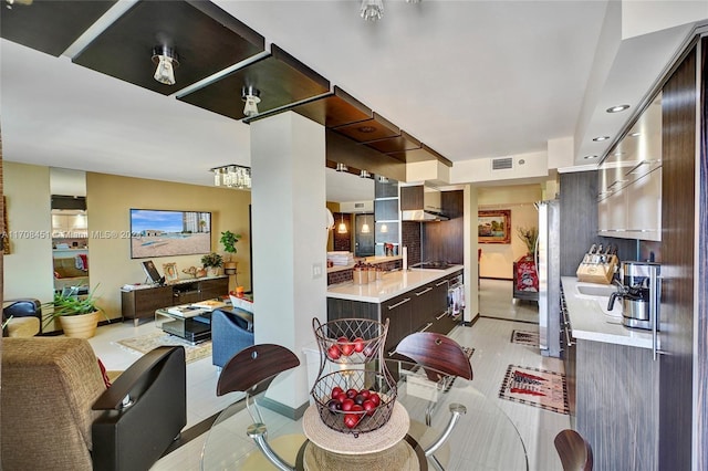 kitchen with cooktop, dark brown cabinetry, and light tile patterned floors