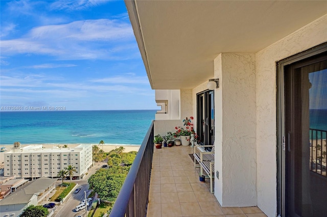 balcony with a beach view and a water view