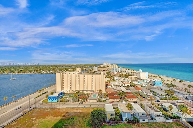 drone / aerial view with a water view and a beach view