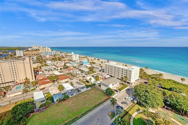 bird's eye view featuring a view of the beach and a water view