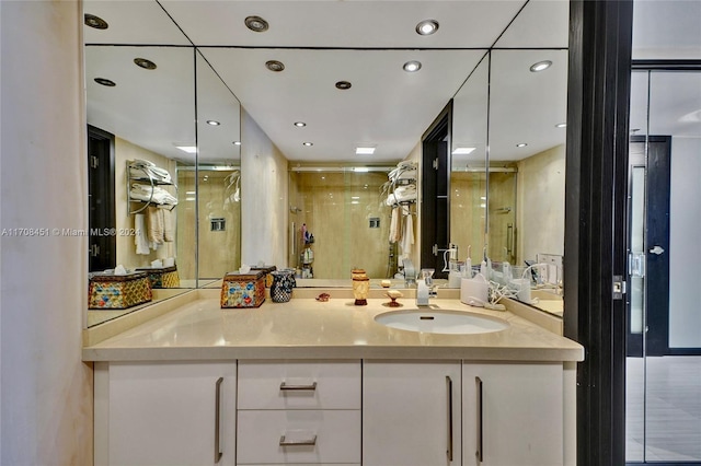 bathroom featuring vanity and a shower with door