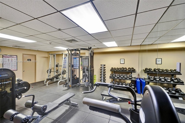 gym with a paneled ceiling