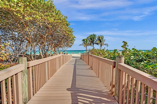 surrounding community featuring a water view and a view of the beach