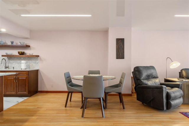 dining room featuring light hardwood / wood-style floors and sink