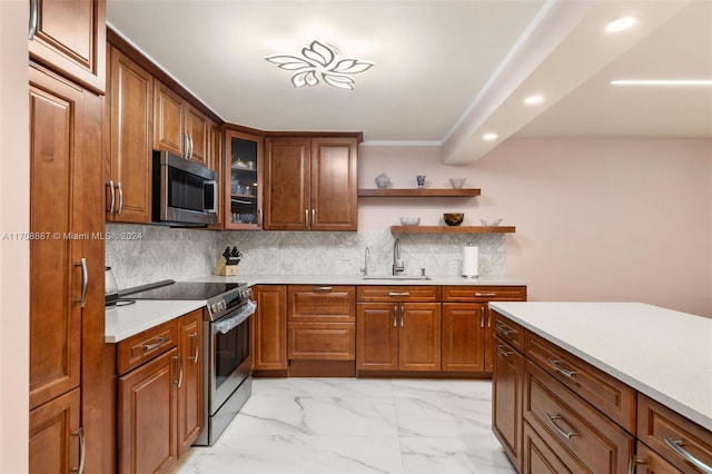 kitchen featuring appliances with stainless steel finishes, backsplash, and sink