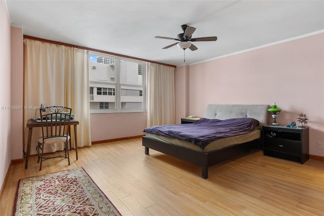 bedroom with light hardwood / wood-style flooring, ceiling fan, and crown molding