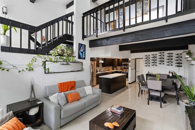 tiled living room with beamed ceiling and a high ceiling