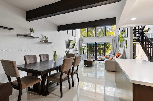 dining area featuring beamed ceiling and light tile patterned floors