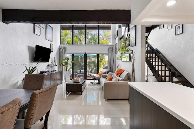 living room with beam ceiling and french doors