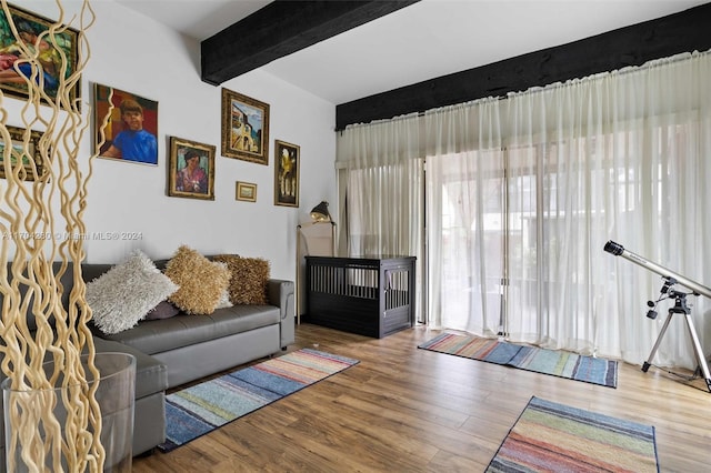 living room featuring wood-type flooring and beam ceiling