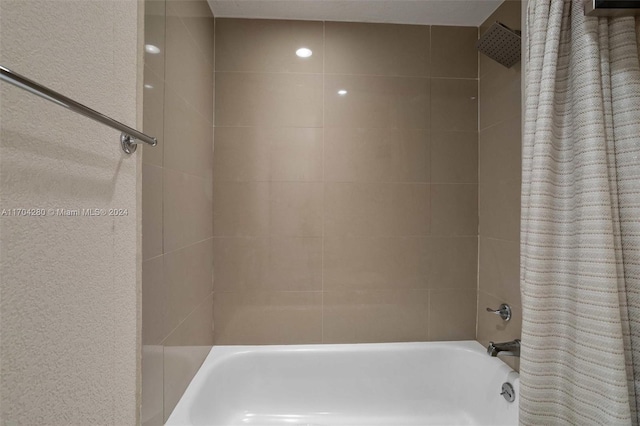 bathroom with shower / bath combination with curtain