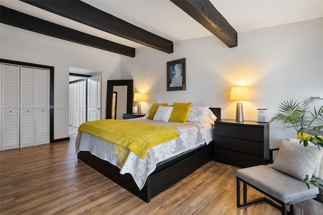 bedroom with beam ceiling and wood-type flooring