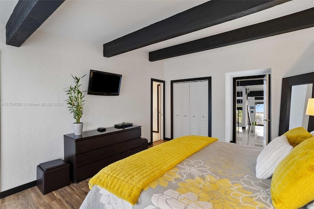 bedroom with hardwood / wood-style floors and beamed ceiling