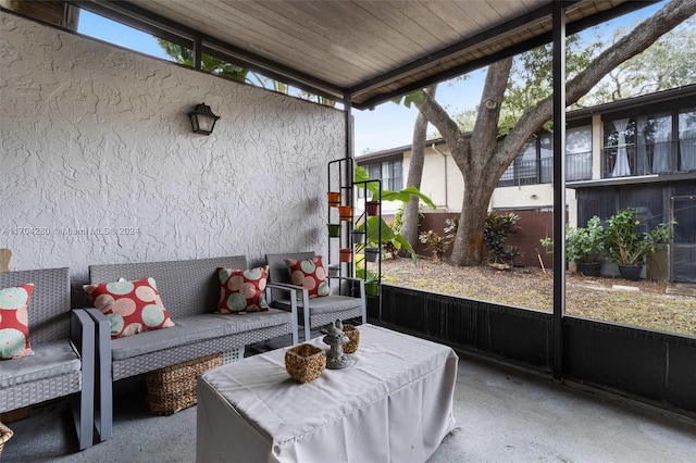 sunroom featuring a wealth of natural light, wood ceiling, and vaulted ceiling