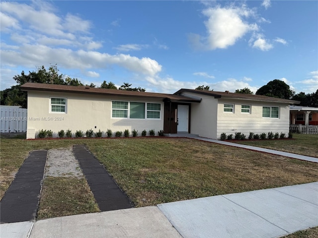 ranch-style home with a front yard