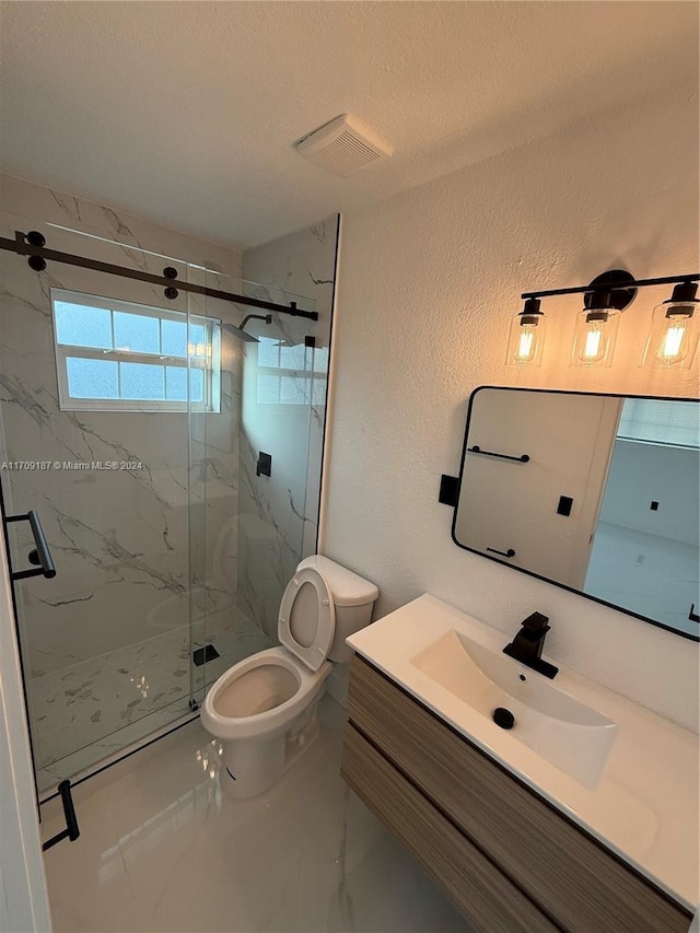 bathroom with vanity, a shower with shower door, a textured ceiling, and toilet