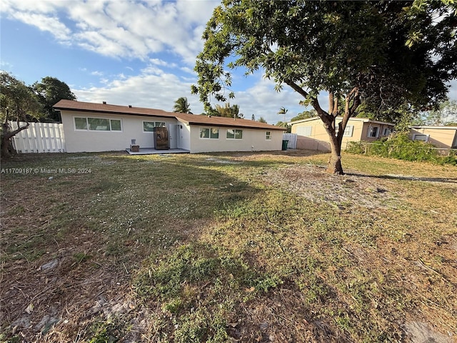 rear view of house with a lawn