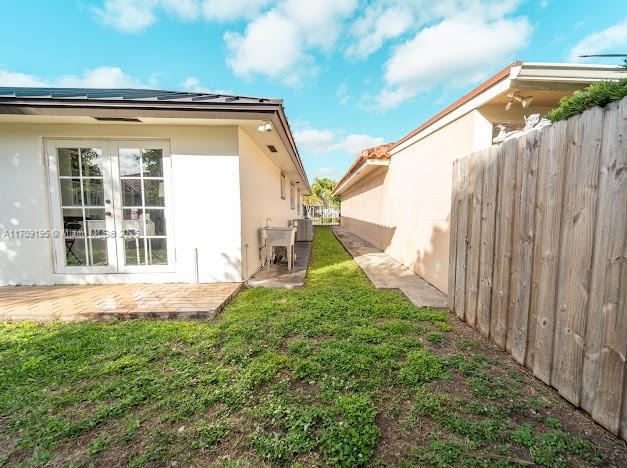 exterior space with french doors, a yard, central AC, and a patio area