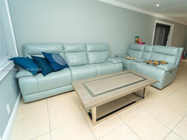 tiled living room featuring crown molding