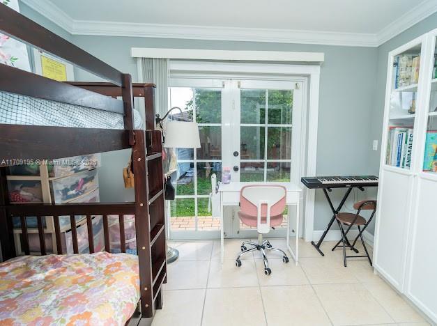 bedroom with crown molding, french doors, and light tile patterned flooring