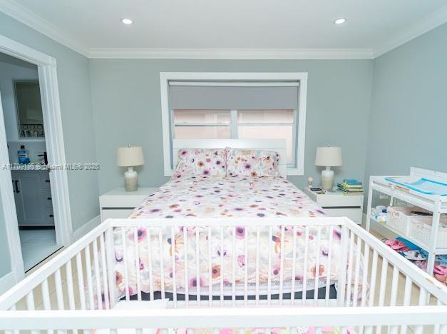 bedroom featuring crown molding