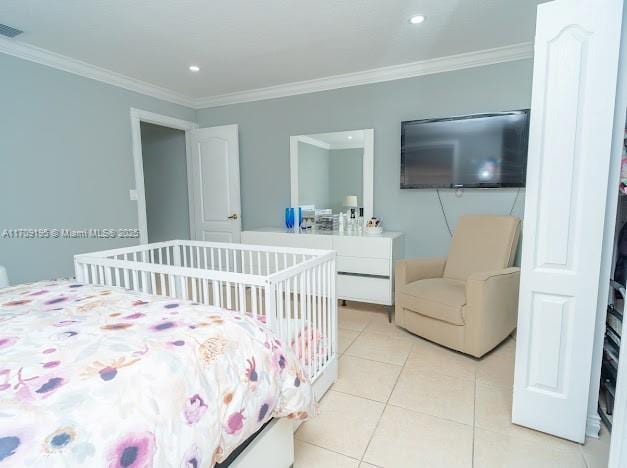 bedroom featuring ornamental molding and light tile patterned floors