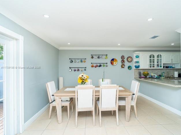 tiled dining space with ornamental molding