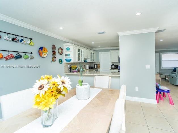 tiled dining area with crown molding