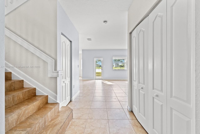 corridor featuring light tile patterned floors