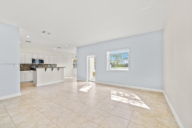 unfurnished living room featuring light tile patterned flooring