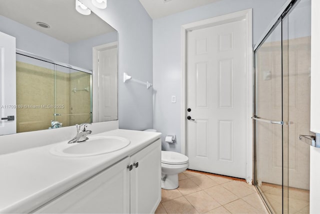 bathroom with toilet, a shower with shower door, tile patterned floors, and vanity