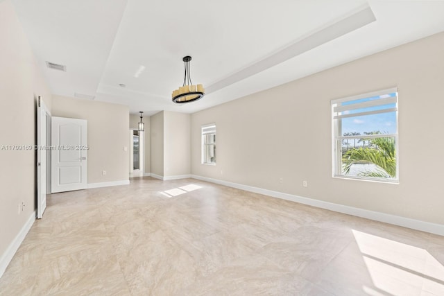 unfurnished room featuring a tray ceiling