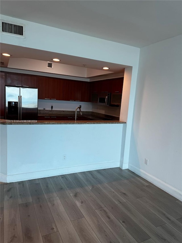 kitchen featuring sink, dark brown cabinets, stainless steel appliances, and hardwood / wood-style flooring