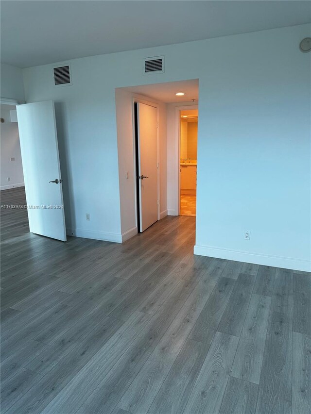 unfurnished room with wood-type flooring