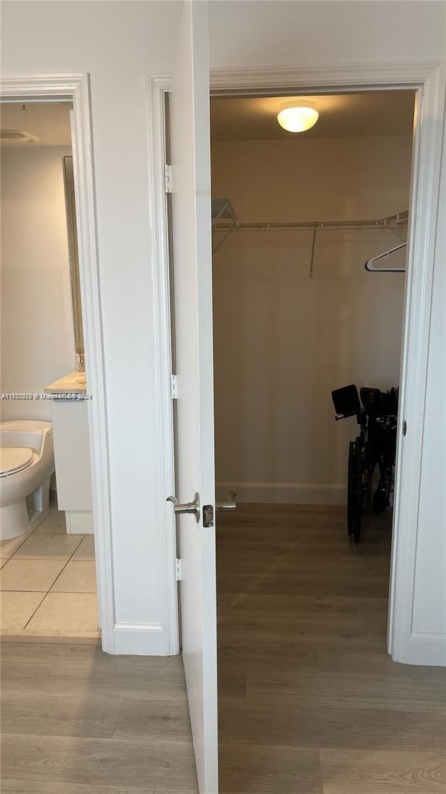 spacious closet featuring light hardwood / wood-style flooring