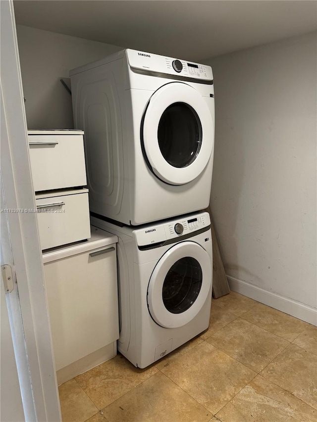 laundry room with stacked washer / drying machine