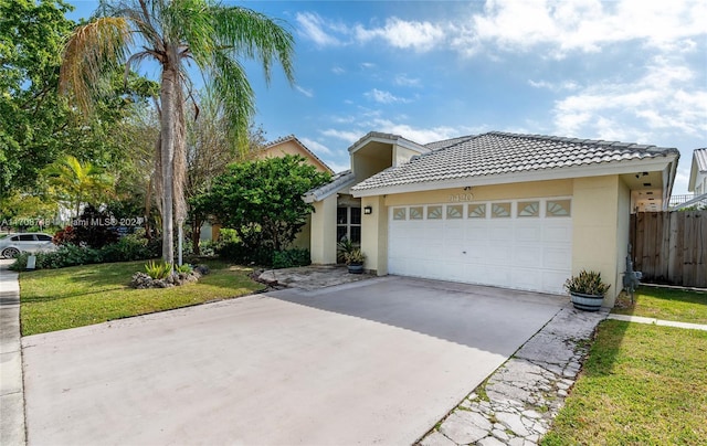 view of front facade featuring a garage and a front lawn