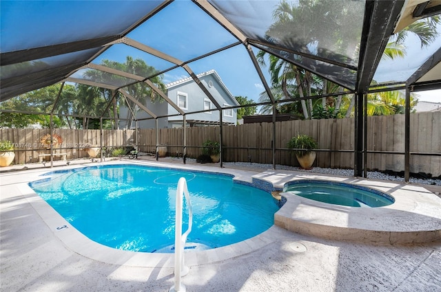 view of swimming pool with glass enclosure, a patio area, and an in ground hot tub