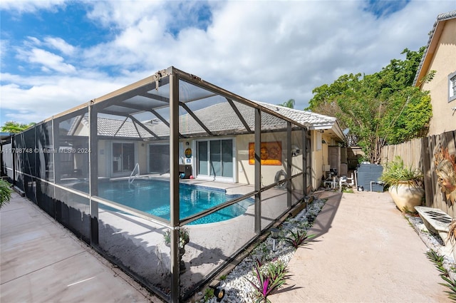 view of swimming pool with a lanai