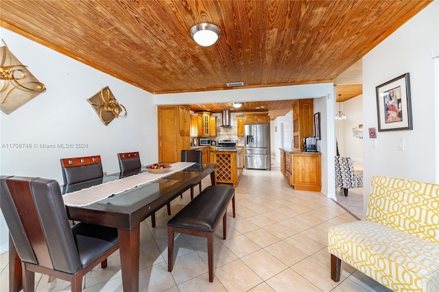 dining space with light tile patterned floors and wood ceiling