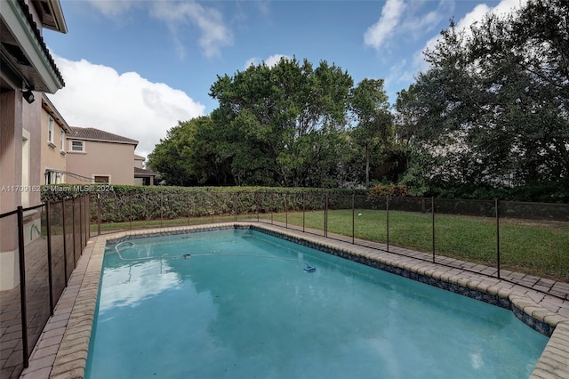 view of pool with a lawn