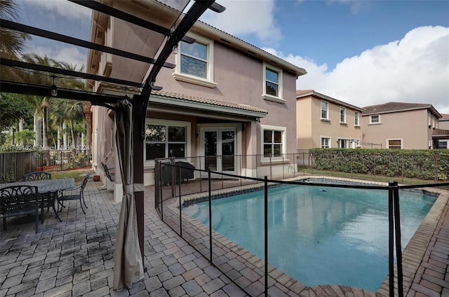 view of swimming pool featuring french doors and a patio