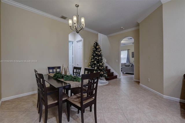 dining area featuring crown molding, light tile patterned floors, and a notable chandelier