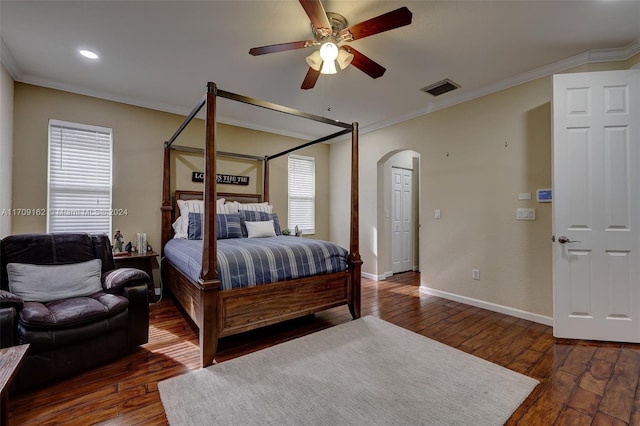 bedroom featuring ceiling fan, crown molding, and dark wood-type flooring