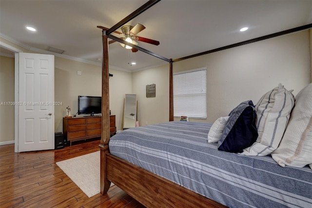 bedroom featuring ceiling fan, hardwood / wood-style floors, and crown molding