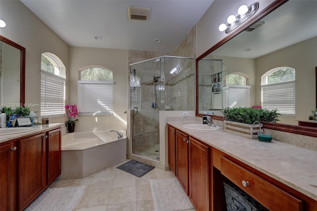 bathroom featuring tile patterned floors, vanity, and shower with separate bathtub