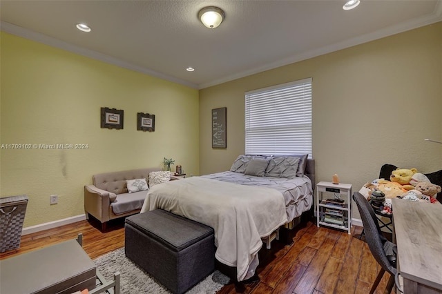 bedroom with wood-type flooring and crown molding